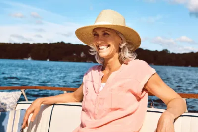 Retirement is all about going with the flow. a mature woman enjoying a relaxing boat ride.